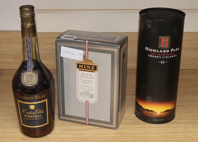 Three bottles: boxed Hine champagne cognac, Martell liqueur cognac and a boxed Highland park 12 year old malt whisky